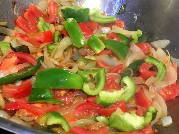 preparing tomato rice with green bell pepper