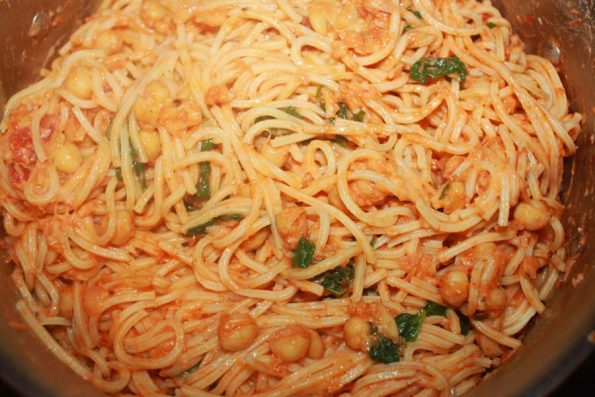 pasta with chickpeas and spinach leaves