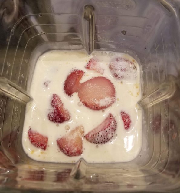 making strawberry milkshake in blender