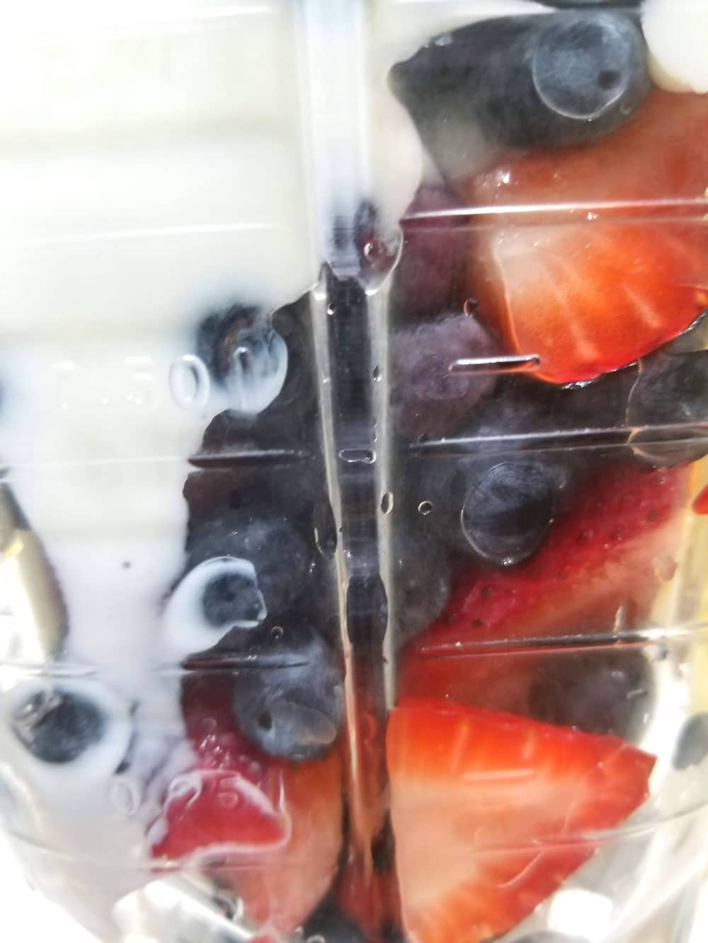 making berry smoothie with yogurt
