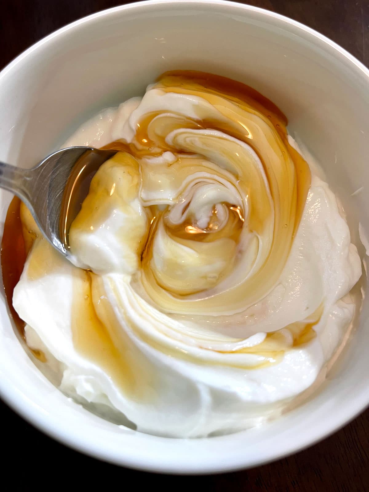 adding honey to greek yogurt