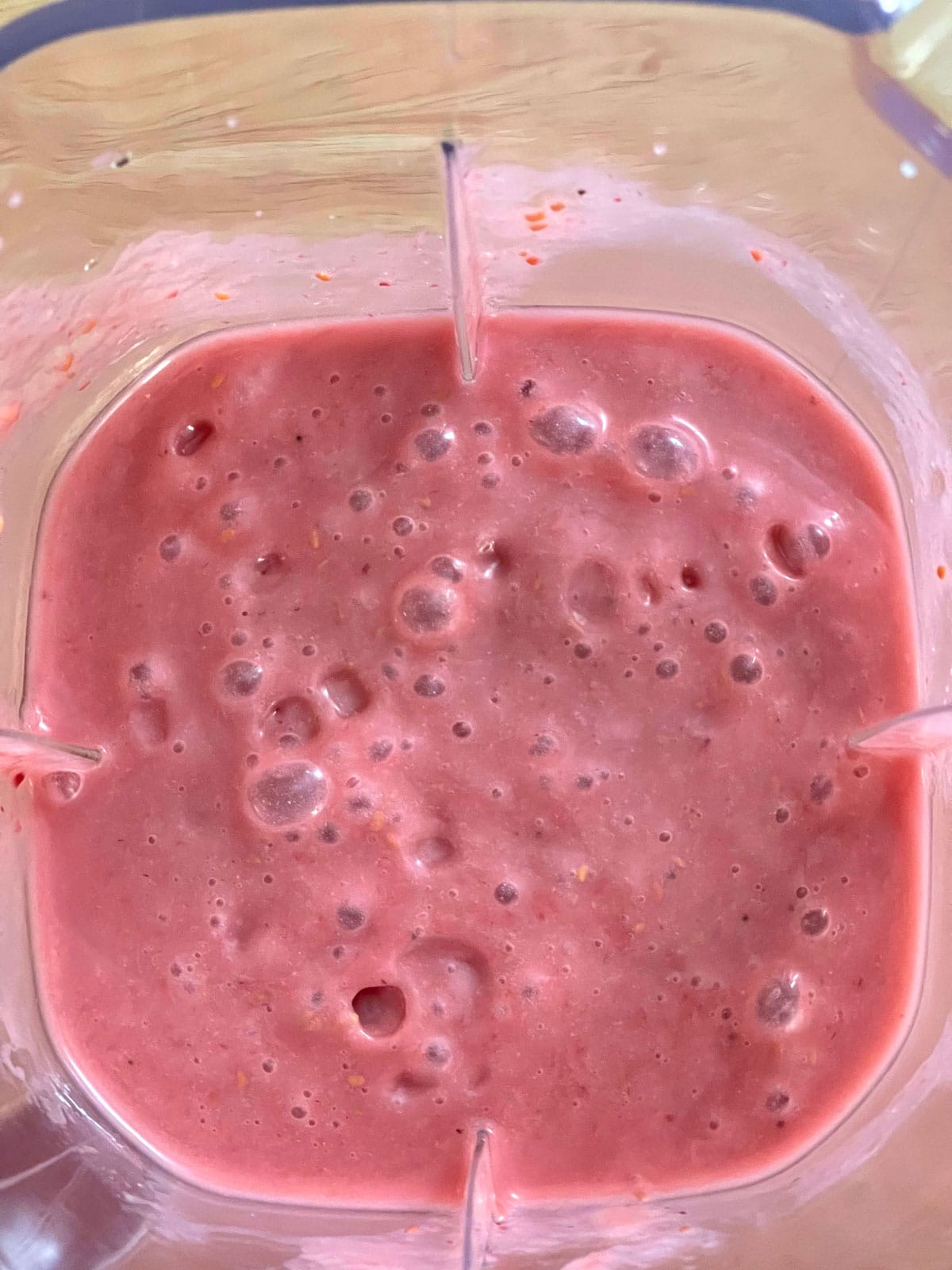 making raspberry banana smoothie in blender