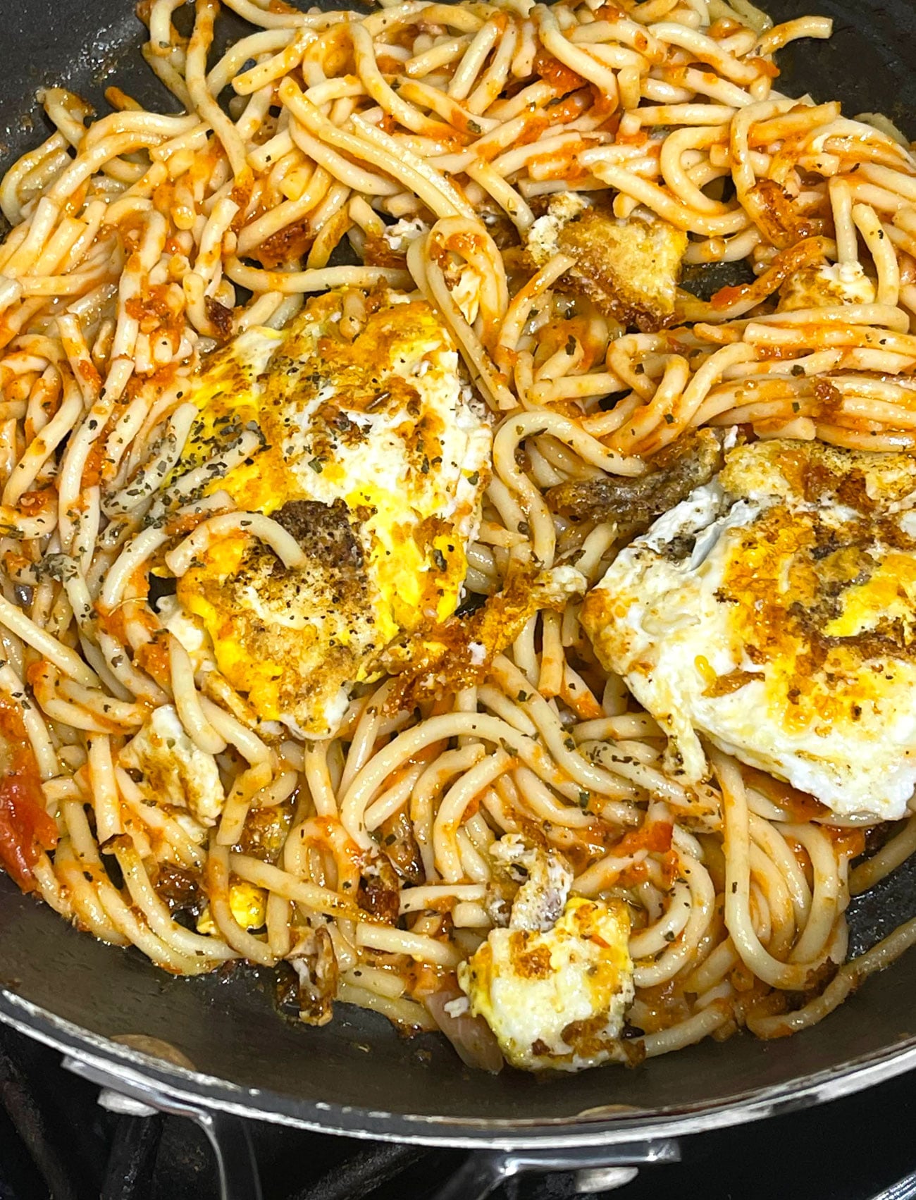 fried spaghetti noodles with fried eggs
