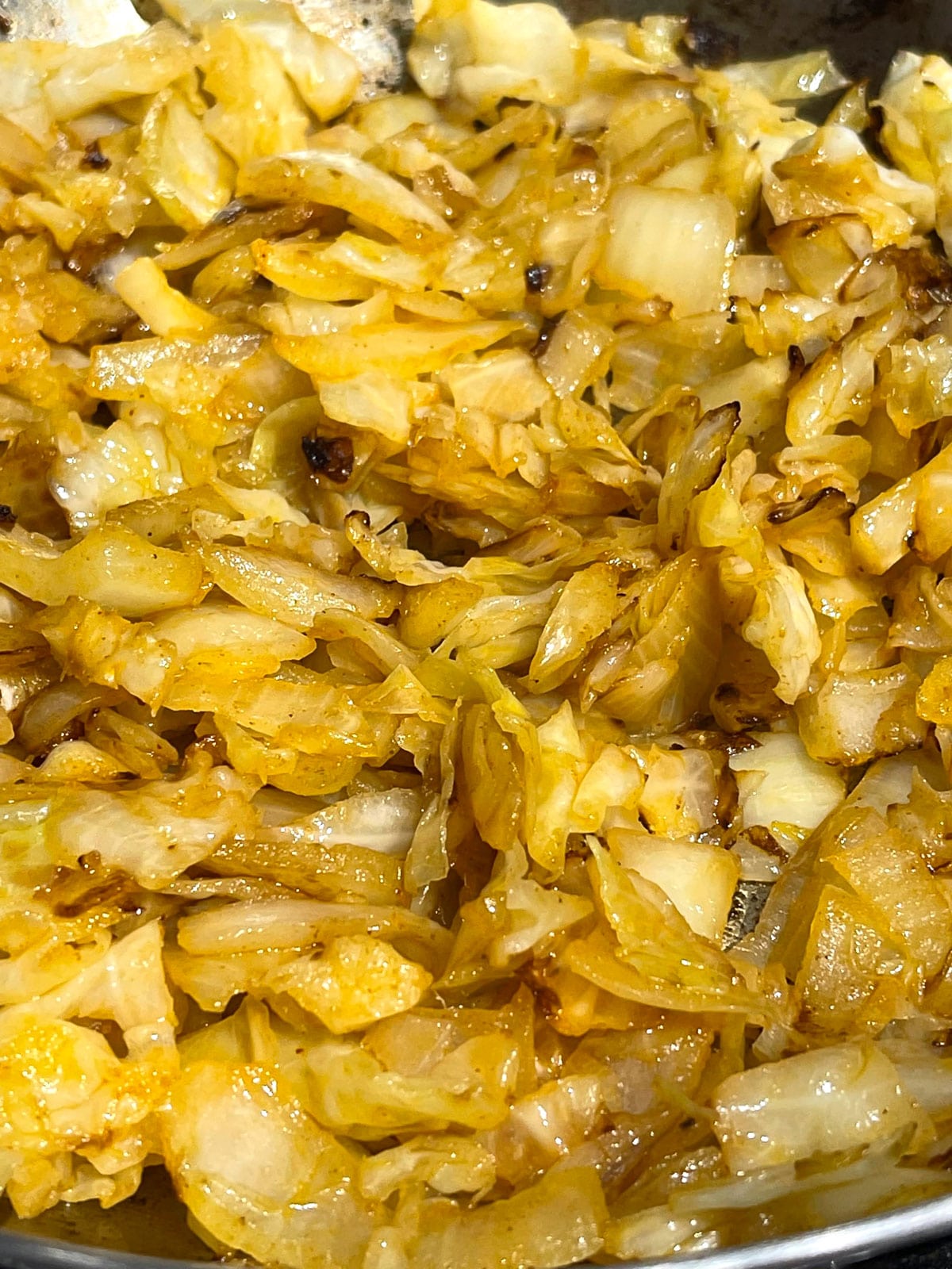 making fried caramelized cabbage and onions