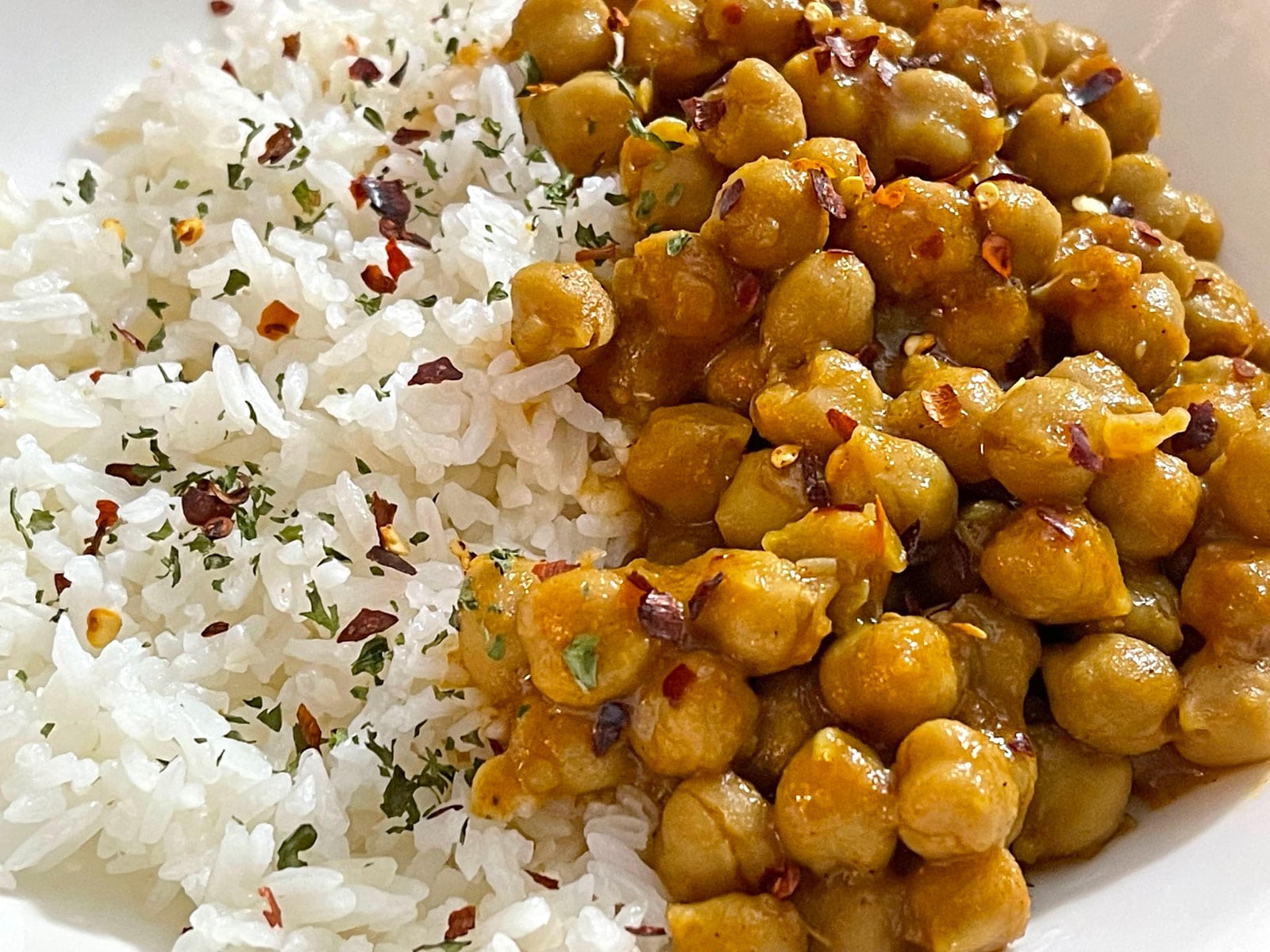 white jasmine seasoned with red chili flakes and served along with chickpea curry