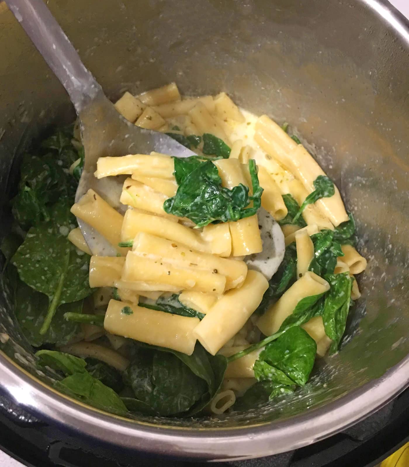 ziti pasta with spinach leaves