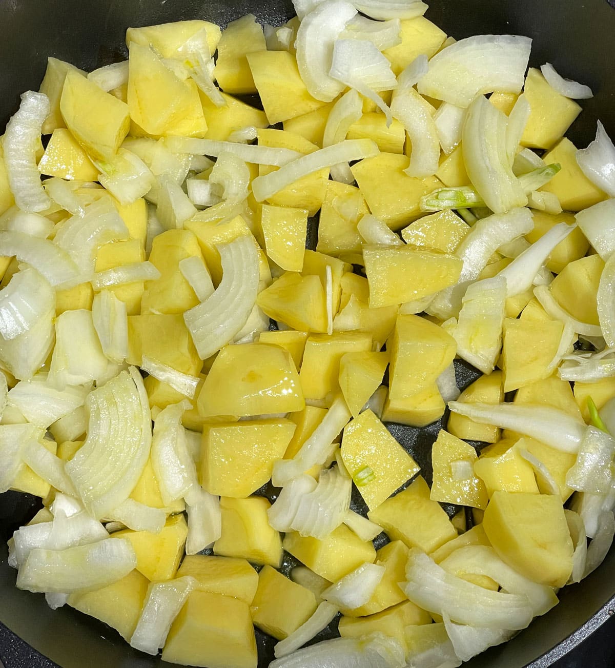 oil mixed with potatoes and onions