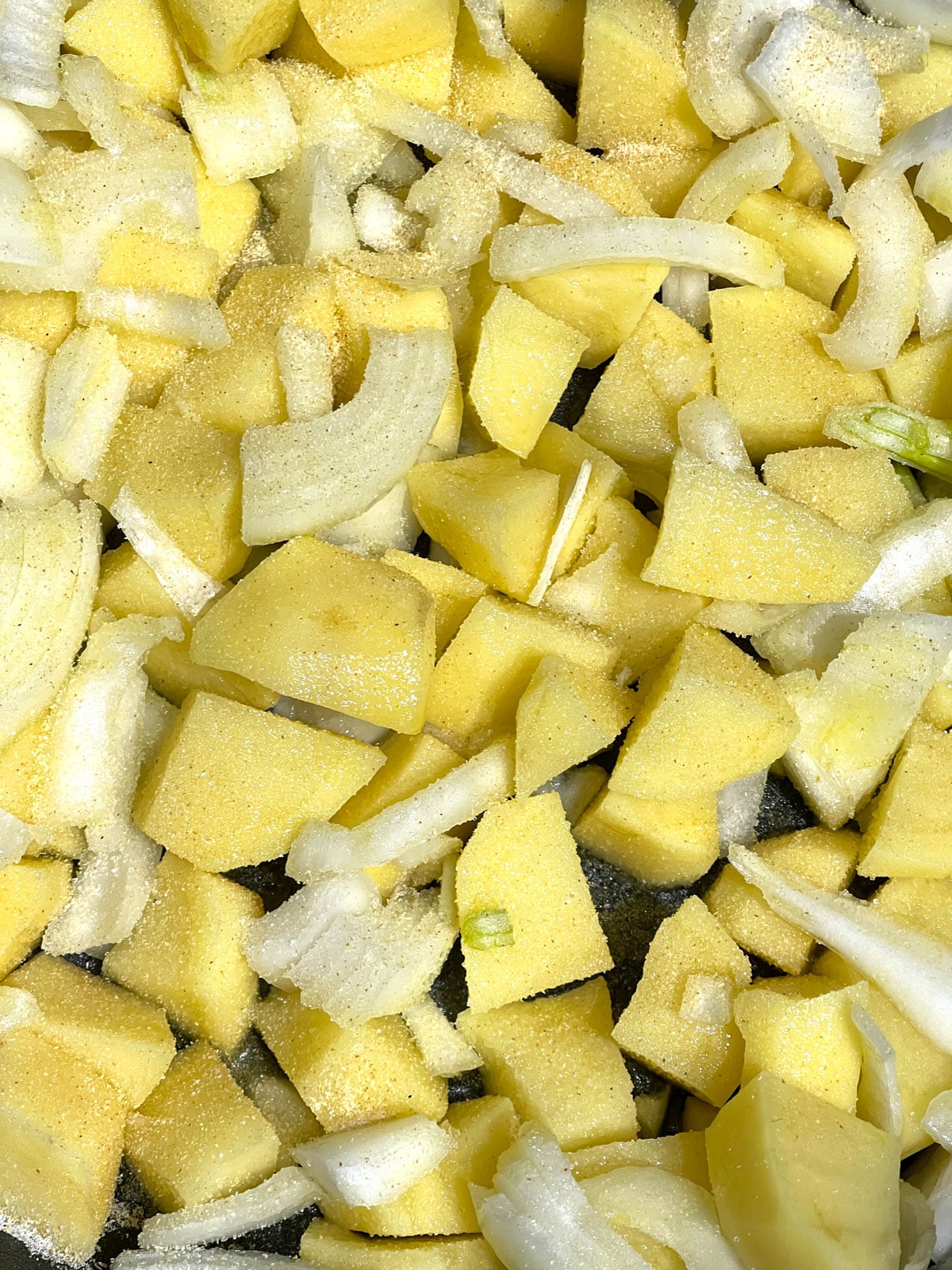 garlic and salt added to potatoes and onions