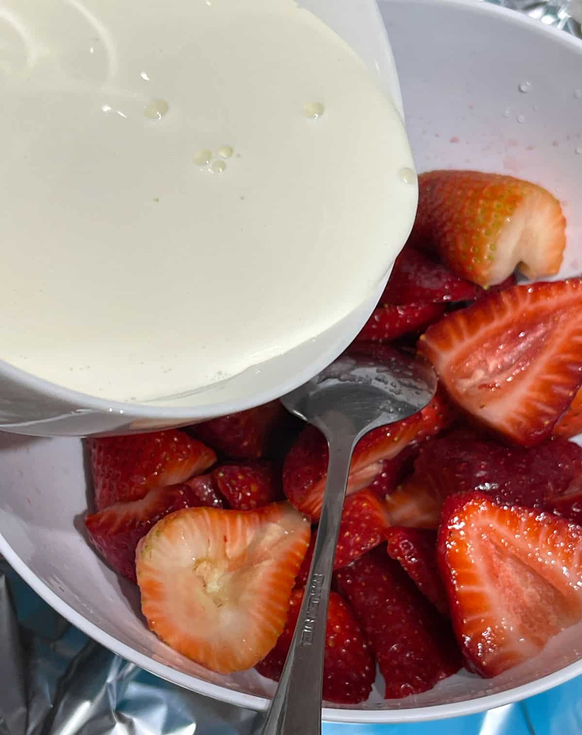 adding cream t strawberries