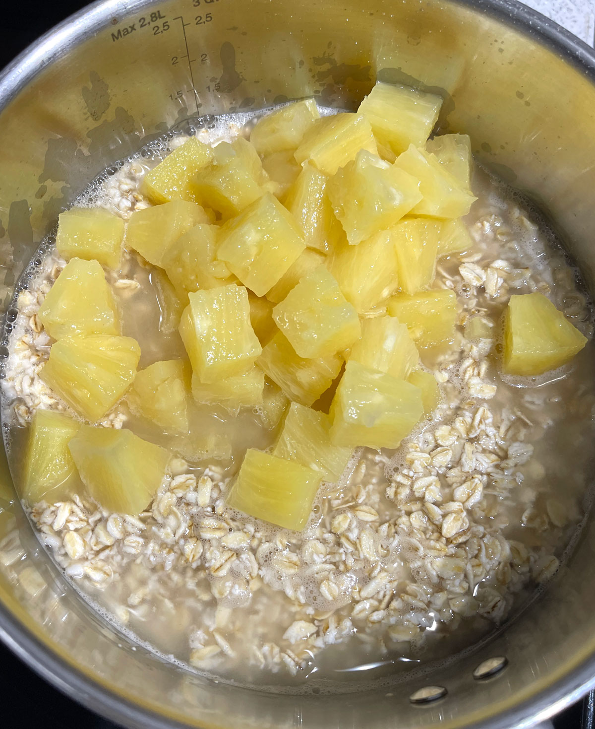oatmeal and pineapples in saucepan