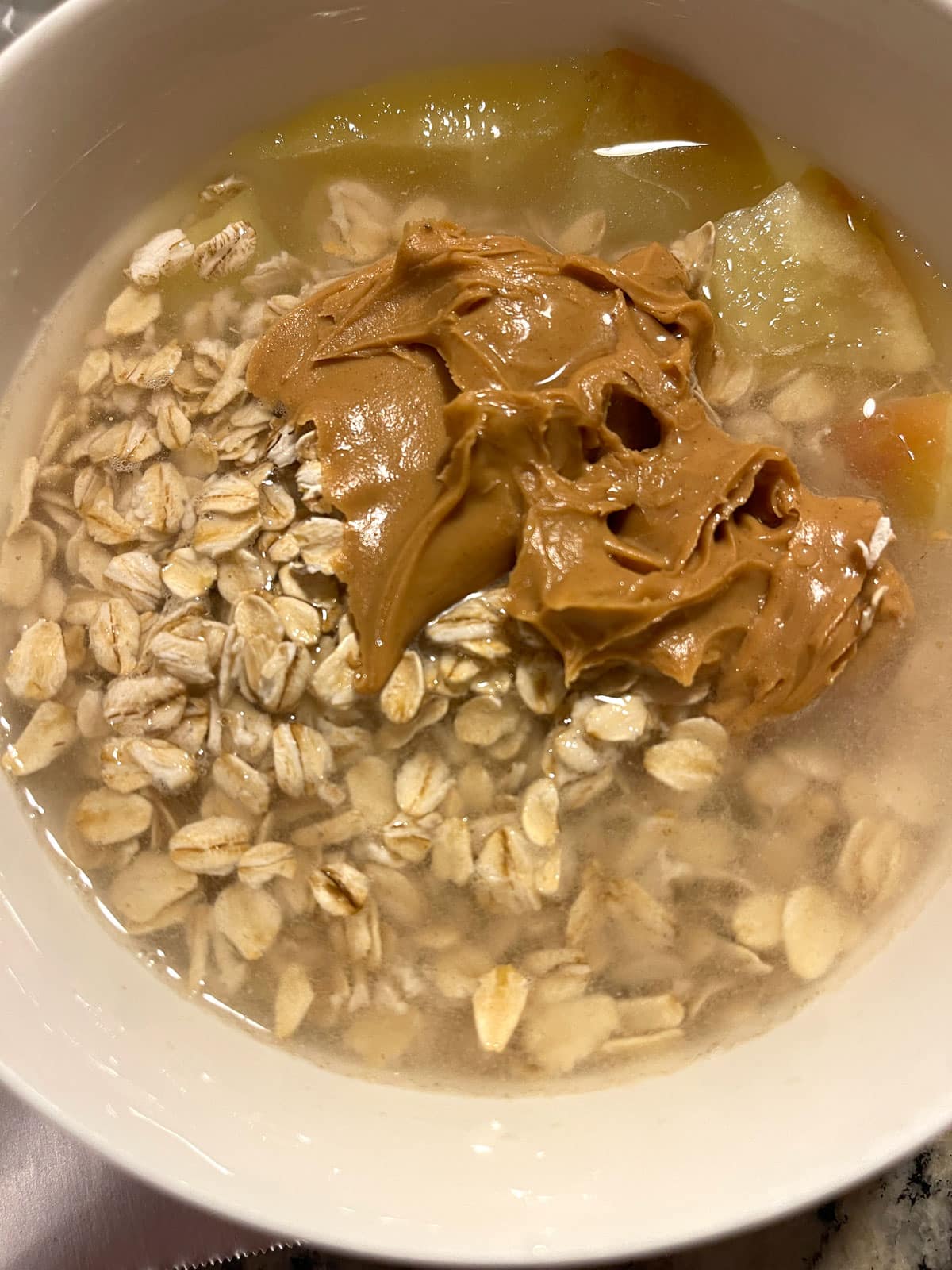 making microwave oatmeal with apples and peanut butter